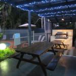 A picnic table and grill in the backyard.